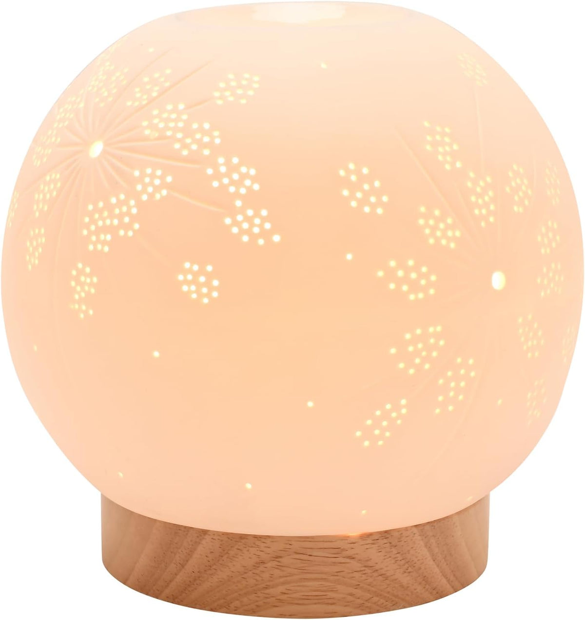 A spherical LED night light with a warm peachy-orange glow, featuring laser-cut floral and star patterns on its semi-translucent dome and resting on a round wooden base.