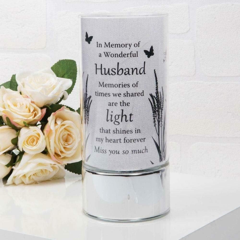 Lamp with engraved text and flowers on a white background