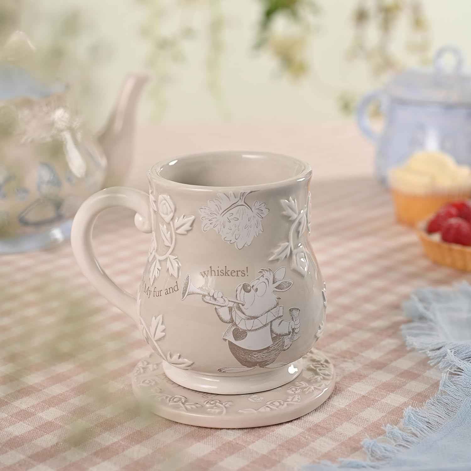 Decorative mug with floral patterns on a checkered tablecloth
