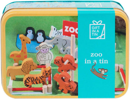 Toy set in a tin labeled 'Zoo in a Tin' with various animal figures and a zookeeper figure.