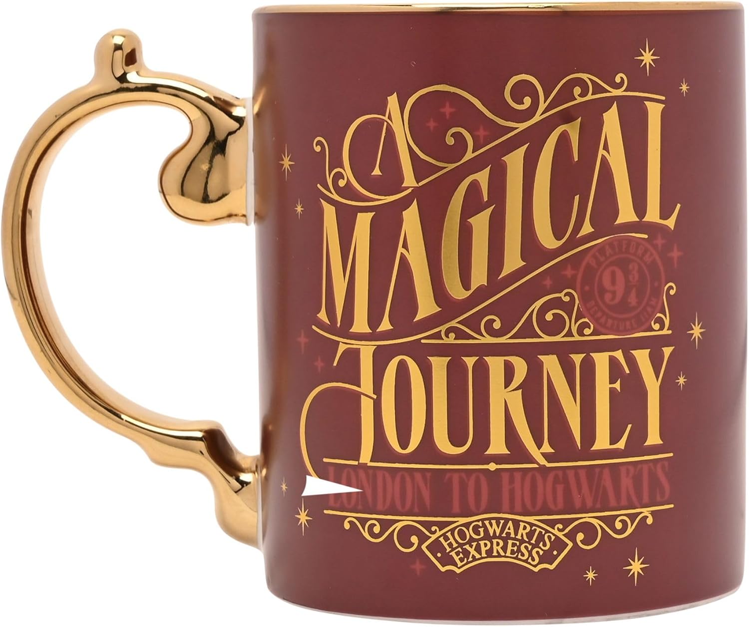 A dark red ceramic mug with a gold handle and gold printed lettering that reads 'A Magical Journey' and 'London to Hogwarts' on a white background.