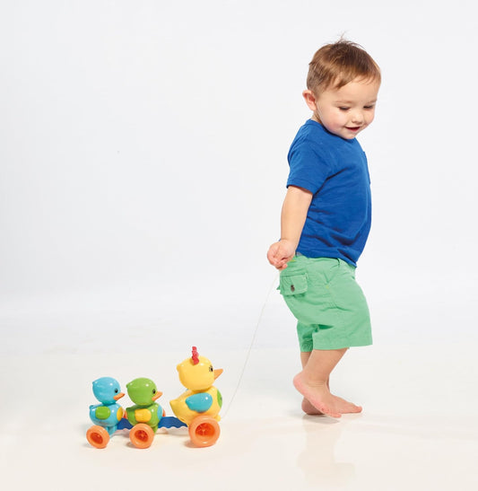 Child playing with a colorful toy on a white background