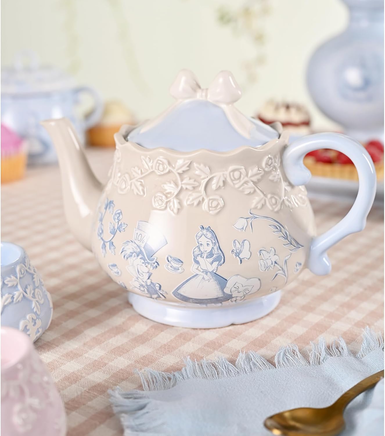 Decorative teapot with floral patterns on a tablecloth