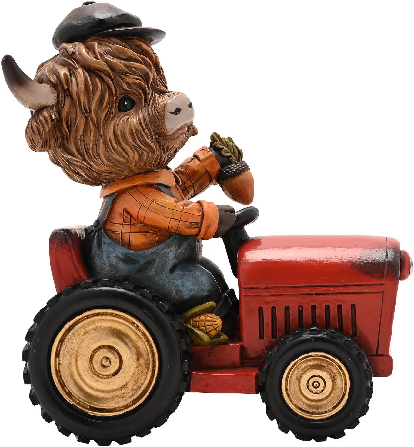 A decorative figurine of a shaggy Highland cow wearing a black cap and an orange plaid shirt, sitting on a red tractor with black tires and gold-colored wheels, isolated on a white background.