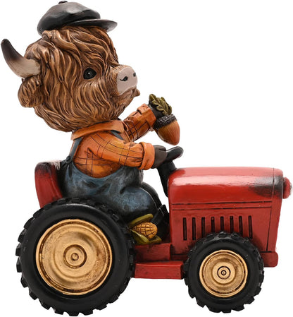 A decorative figurine of a shaggy Highland cow wearing a black cap and an orange plaid shirt, sitting on a red tractor with black tires and gold-colored wheels, isolated on a white background.
