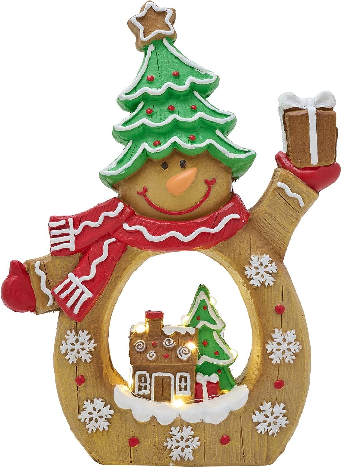 A festive snowman gingerbread decoration with a green Christmas tree hat, red and white striped scarf, and a warm wooden body featuring a glowing holiday village scene inside.