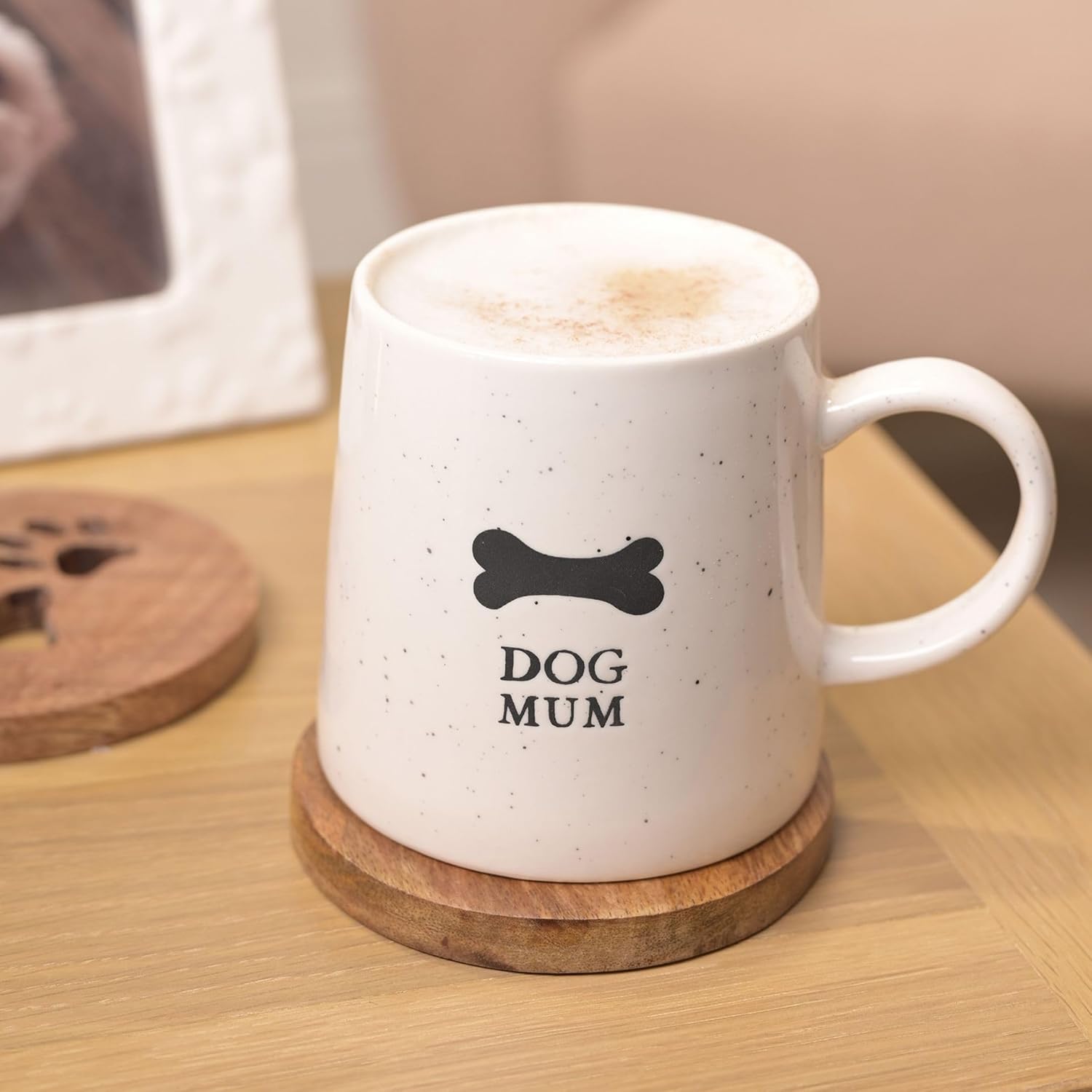 White mug with 'DOG MUM' text on a wooden coaster