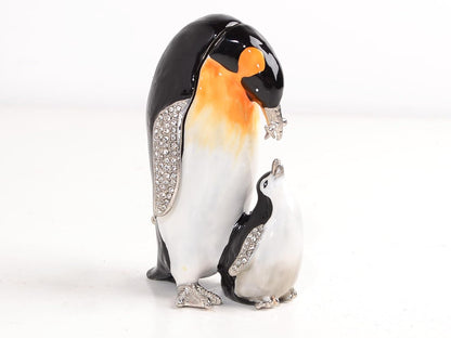 Decorative penguin figurine with a smaller penguin on a white background