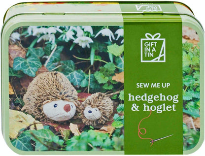 Gift in a tin with hedgehog and hoglet plush toys and sewing kit.