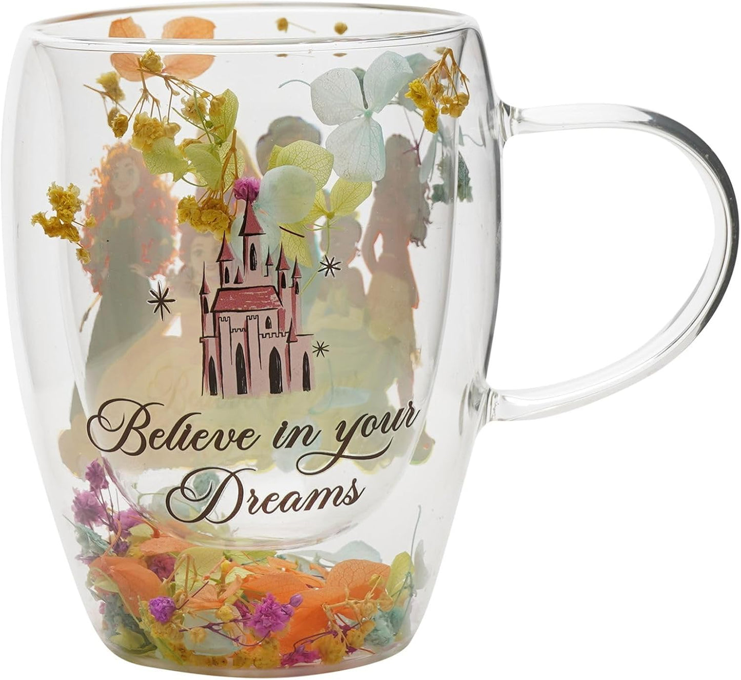 Clear glass double-walled mug with a printed fairy tale castle, dried flowers, and the phrase 'Believe in your Dreams' on a white background.