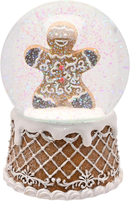 A gingerbread-themed snow globe figurine featuring a decorated gingerbread man inside a clear glass-like sphere with glitter, mounted on a white and brown lattice-patterned base.