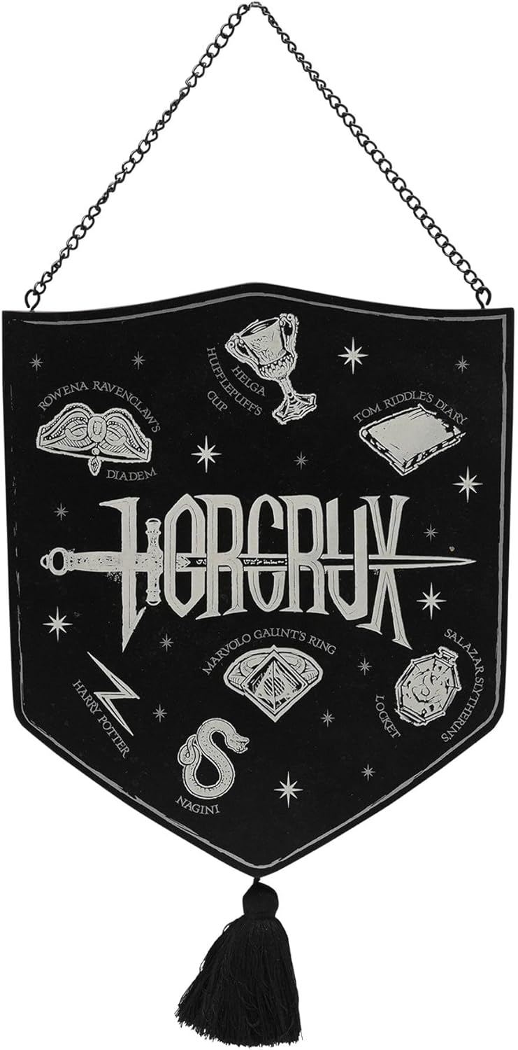 A black shield-shaped wall hanging banner with a silver-tone metal chain at the top and a black tassel at the bottom. The banner features white embroidered illustrations and text related to the fantasy band Horcrux, including the Horcrux logo, a dagger, an eye, and other magical symbols.