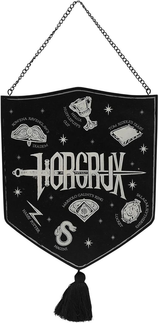 A black shield-shaped wall hanging banner with a silver-tone metal chain at the top and a black tassel at the bottom. The banner features white embroidered illustrations and text related to the fantasy band Horcrux, including the Horcrux logo, a dagger, an eye, and other magical symbols.