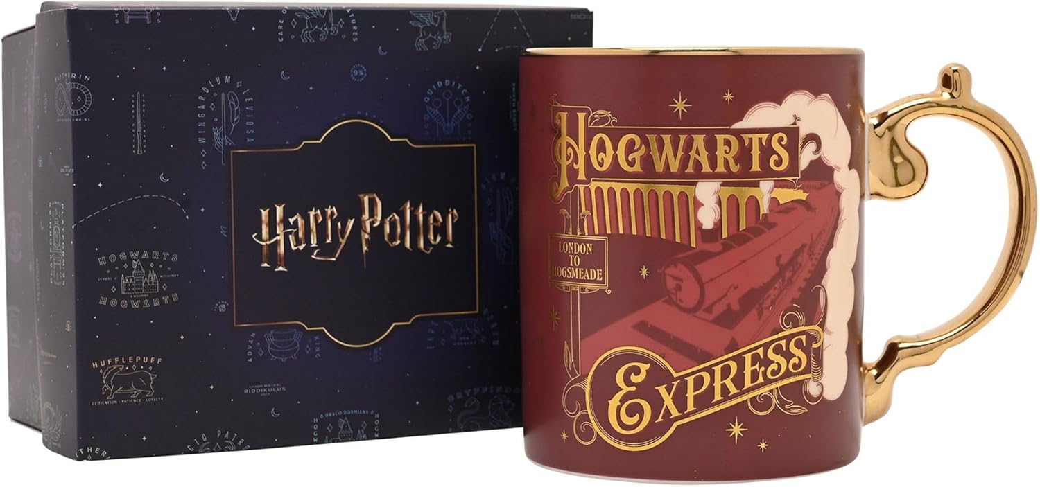 A Harry Potter Hogwarts Express ceramic mug in dark red with gold lettering and a gold handle, shown next to its dark blue branded gift box.
