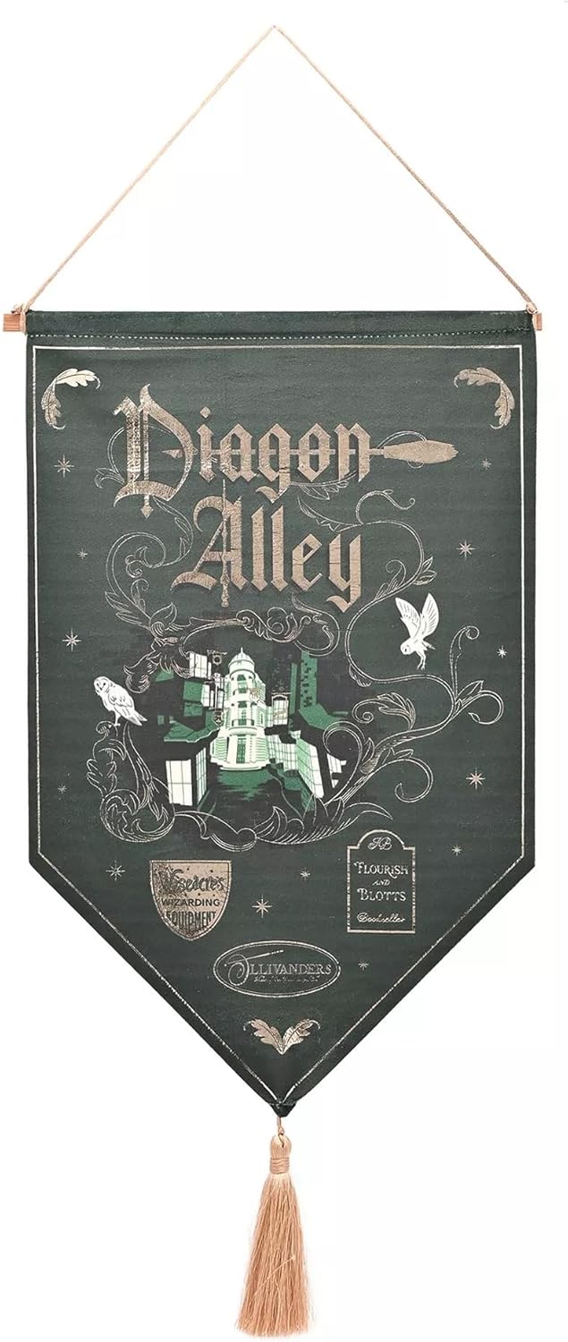 A hanging decorative wall banner featuring the text 'Diagon Alley' in ornate lettering, with illustrated owl, bird, house, and wand motifs on a dark green background. The banner has a wooden hanger at the top and a tassel at the bottom.