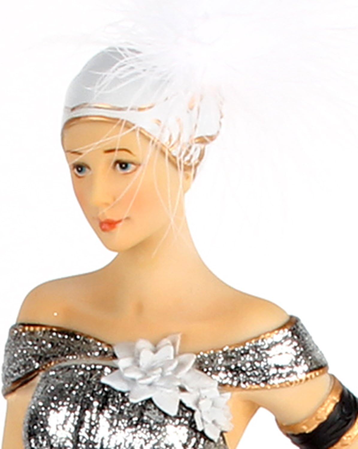 Mannequin wearing a silver sequin outfit with a white flower and headscarf on a white background