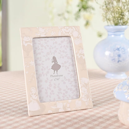 Floral-patterned photo frame on a textured surface with a blurred background
