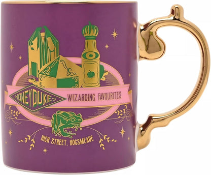 A purple ceramic mug with a gold handle and gold rim, featuring a 'Honeyduke Wizarding Favourites' design with green and gold illustrations of Hogwarts symbols and text.