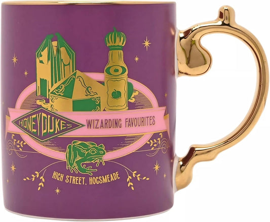 A purple ceramic mug with a gold handle and gold rim, featuring a 'Honeyduke Wizarding Favourites' design with green and gold illustrations of Hogwarts symbols and text.