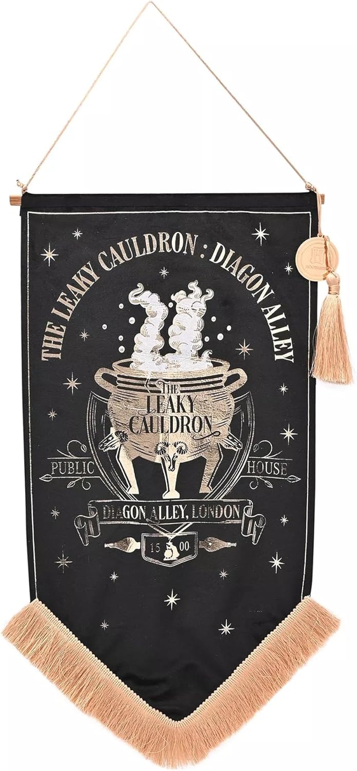 A black fabric wall banner featuring a gold-toned Cauldron of Fire design with the text 'The Leaky Cauldron - Dragon Alley' and 'Public House No. 1 Gon Alley, London 2', hanging from a cord with tassels.