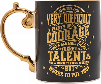 A black ceramic mug with a gold handle and gold printed text featuring motivational quotes, shown on a plain white background.