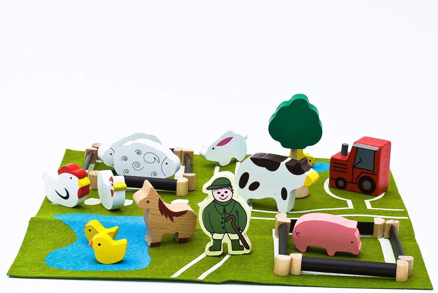 Set of wooden farm animals and a farmer on a green play mat with white lines.