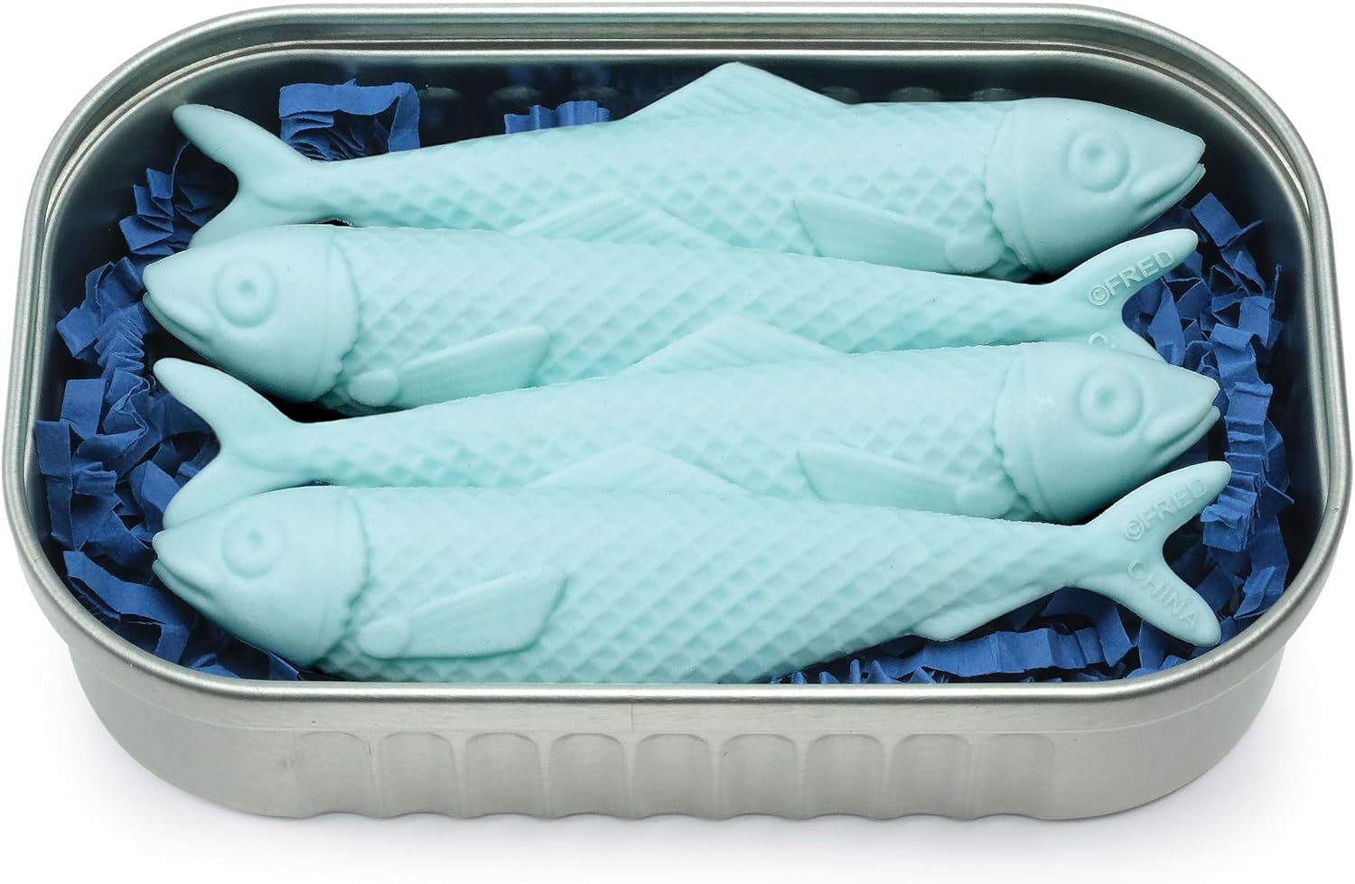 Blue fish-shaped objects in a metal tin with blue tissue paper