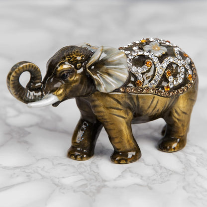 Decorative elephant figurine with intricate designs on a marble surface