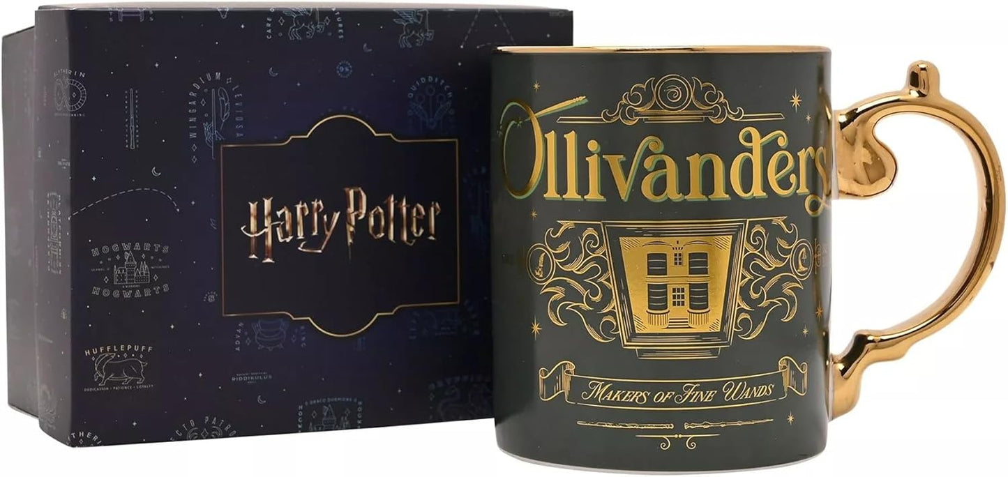A dark green Harry Potter Ollivander mug with gold lettering and a gold handle, shown next to its dark blue branded gift box.