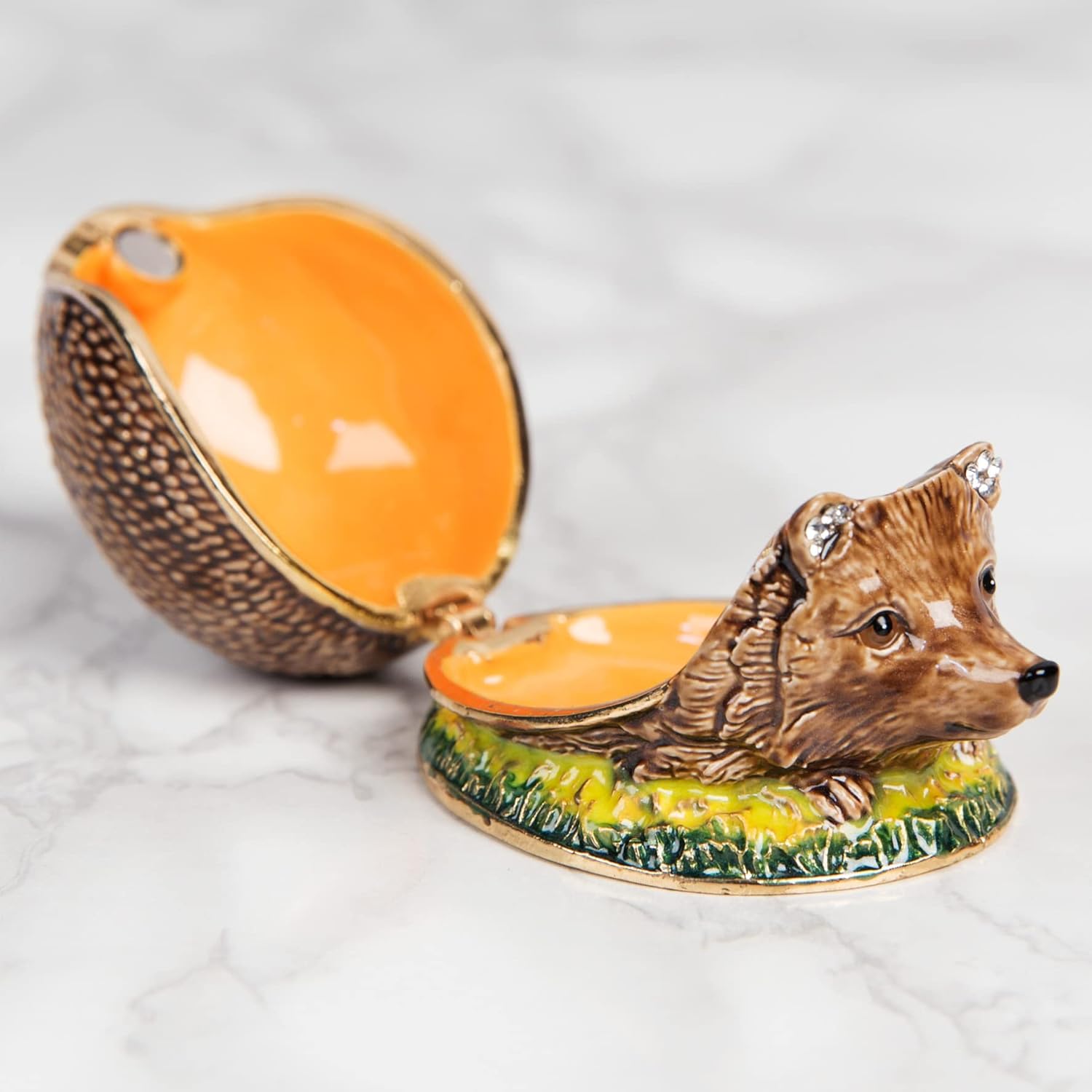 Decorative box shaped like a hedgehog with an open orange lid on a white background