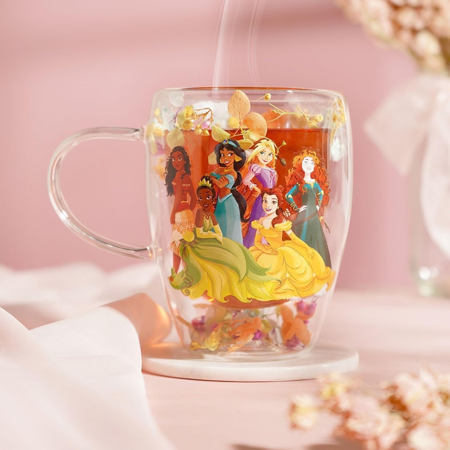 Clear mug with Disney princesses design on a pink background