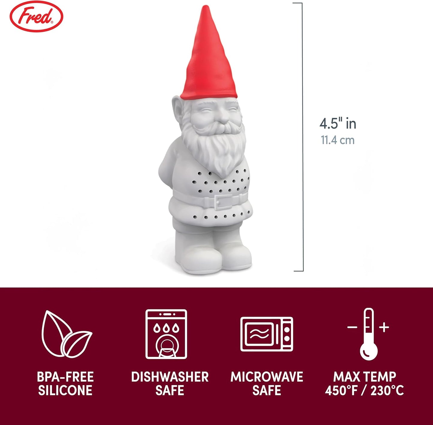 Tea infuser shaped like a gnome in a glass of tea on a wooden table with plants in the background.