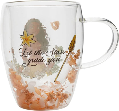 Clear glass mug with a printed design featuring a woman's silhouette, a yellow flower, the phrase 'Let the Stars guide you' in script, and dried orange flowers inside the mug.