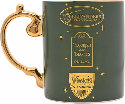 A dark green ceramic mug with gold metallic accents, featuring the 'Harry Potter' character Ollivander's branding and gold decorative text and star motifs.