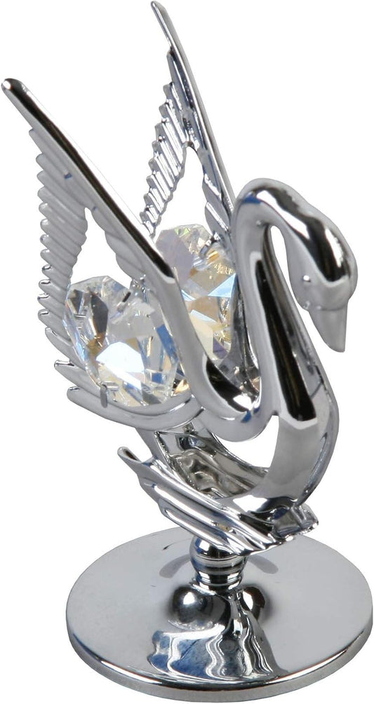 Metallic swan figurine with crystal in the centre on a white background