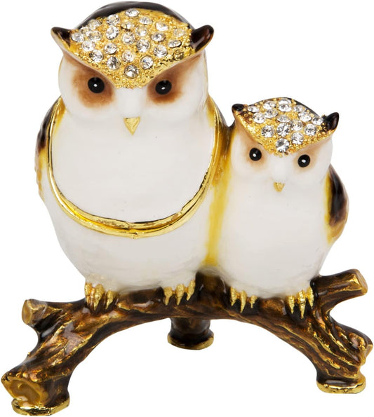 Decorative owl figurine with jewelled hats on a white background