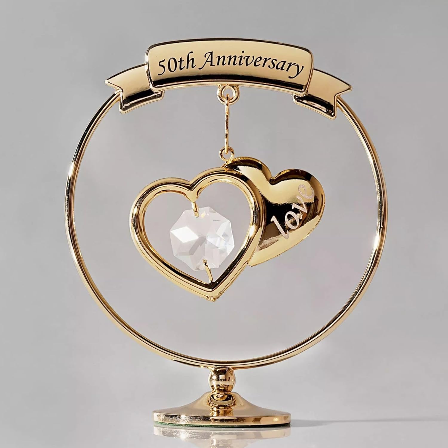 Gold 50th Anniversary ornament with heart design on a gray background