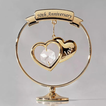 Gold 50th Anniversary ornament with heart design on a gray background