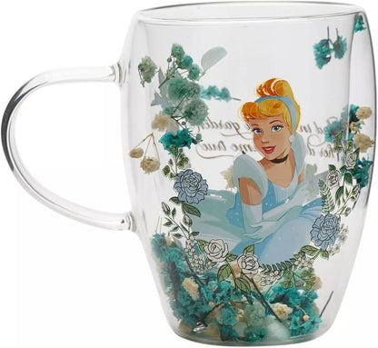Clear glass mug featuring a printed illustration of Cinderella in a light blue dress, surrounded by blue and white flowers and decorative script on a white background.