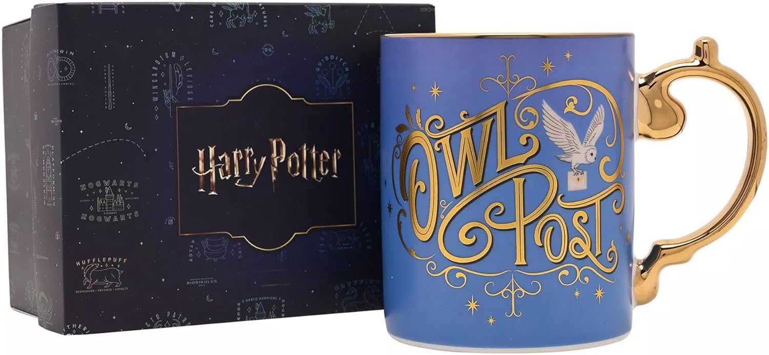 A blue ceramic Harry Potter Owl Post mug with gold lettering and a gold handle, shown next to its dark navy blue packaging box.
