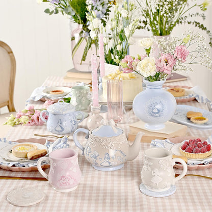Tea set on a table with flowers and pastries