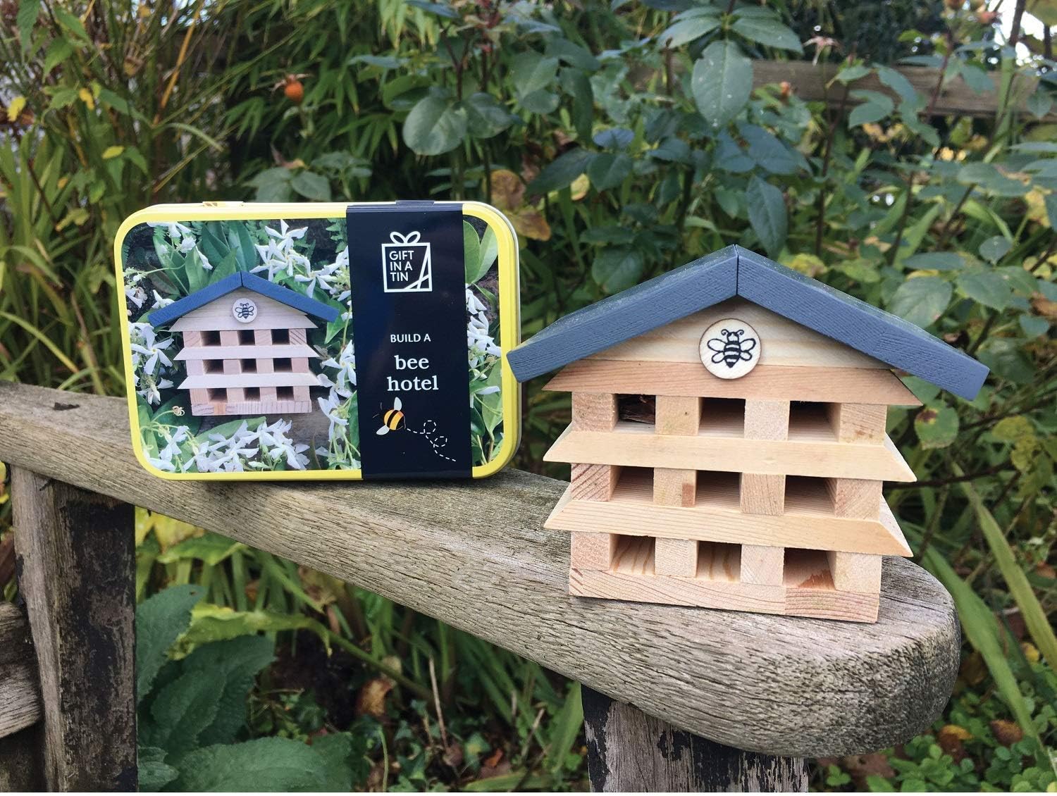 Bee hotel with packaging on a wooden surface outdoors