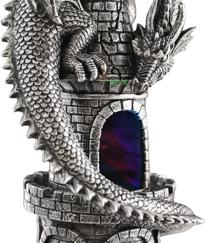 Decorative figurine of a dragon on a castle with a colorful inside.