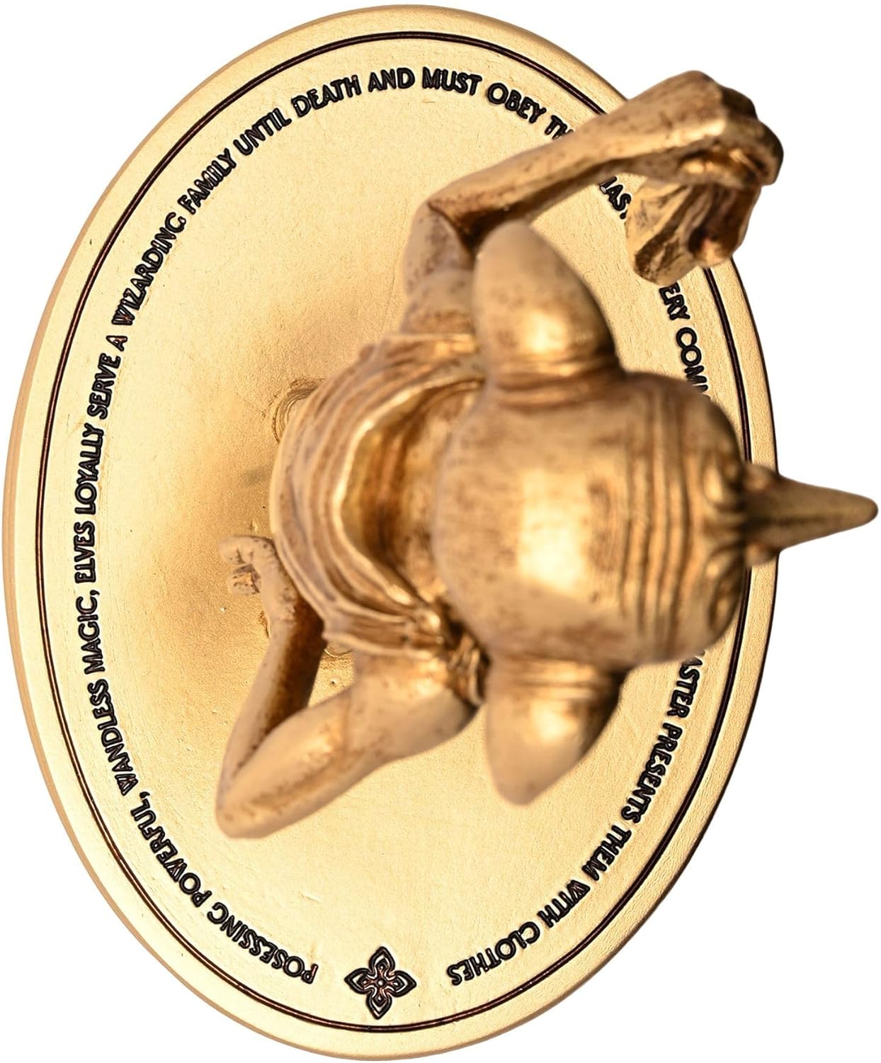 Decorative gold plaque with a Dobby figure and engraved text on a white background