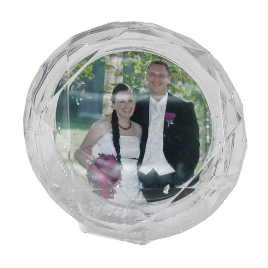 Clear crystal ball with a photo of a couple on a white background