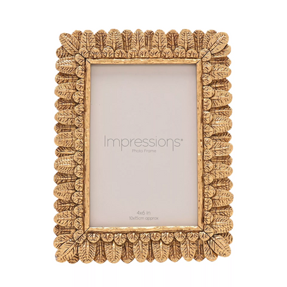 Decorative gold photo frame with 'Impressions' branding on a white background