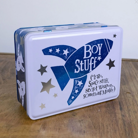 Tin box with 'Boy Stuff' design featuring a blue rocket and stars on a white background.