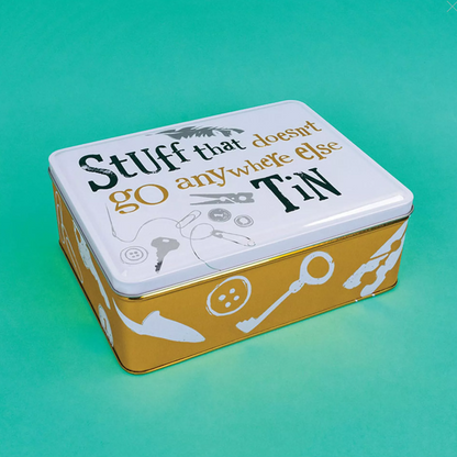 Metal tin with decorative design and text on a teal background