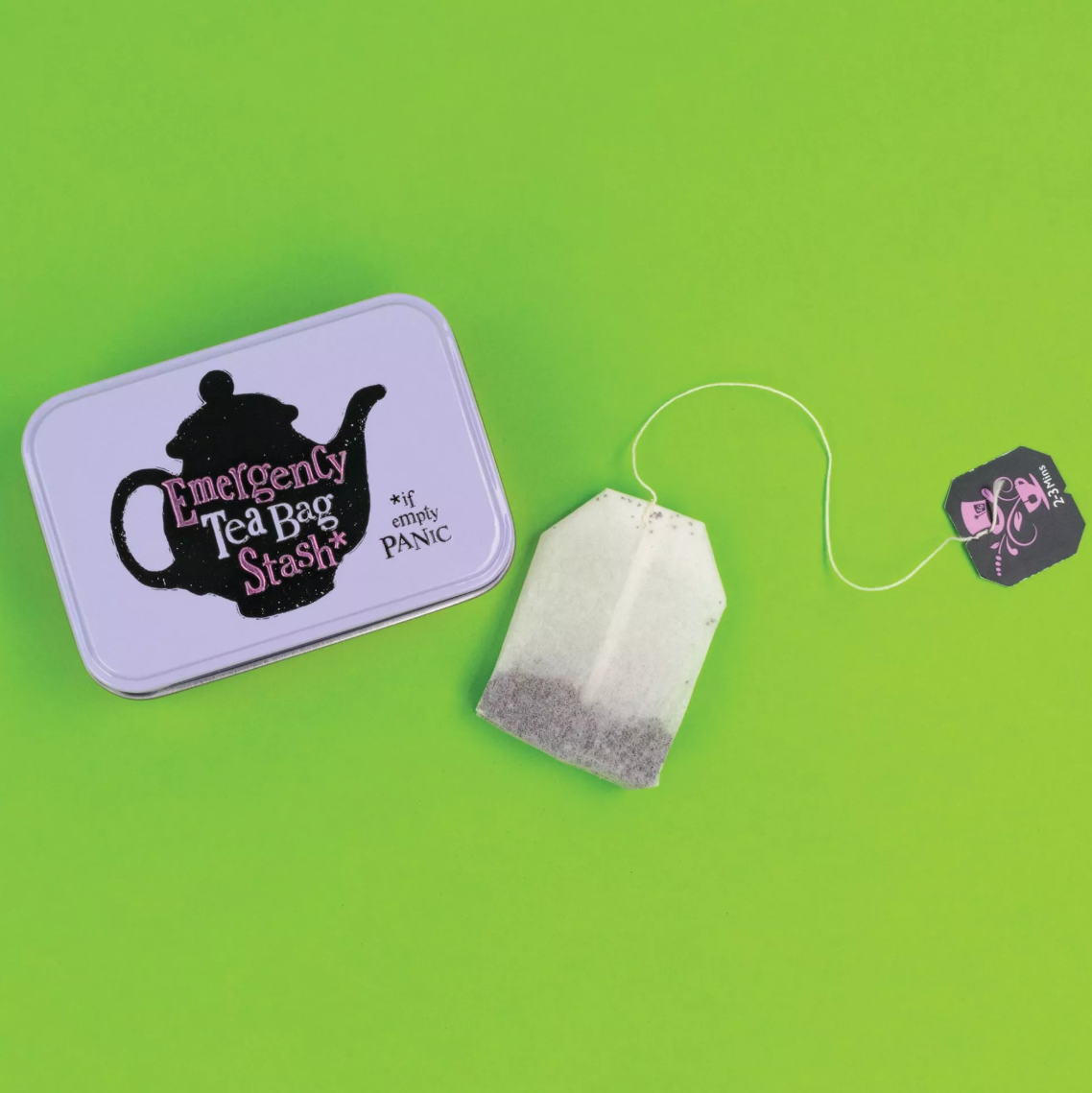 Brightside Emergency Tea Bag Stash Tin – Metallic Tea Bag Storage Tin for Tea Lovers WITH TEA BAG ON GREEN BACKGROUND