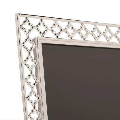 Decorative silver frame with intricate patterns on a white background
